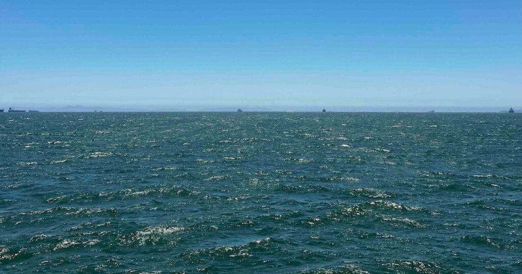 Calm blue ocean water representing mindfulness and mental health therapy.